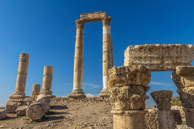 Ruins of temple against clear blue sky