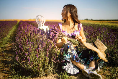 Portrait of young asian woman sitting on lavender field