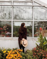 Woman sitting in greenhouse