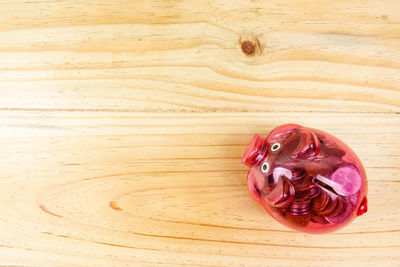 Directly above view of piggy bank on wooden table