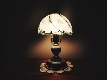 Close-up of electric lamp at home