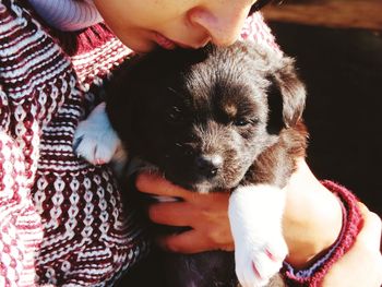 Midsection of woman holding puppy