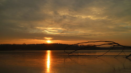 Scenic view of lake against sky during sunset