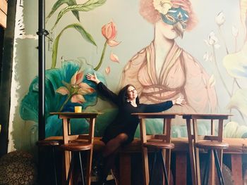 Woman sitting on table in restaurant