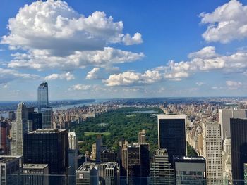 Aerial view of buildings in city against sky