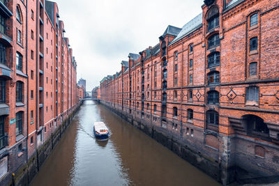 Canal amidst buildings in city