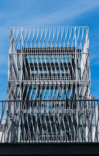 Close-up of metallic structure against blue sky