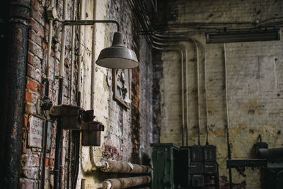 View of illuminated lamp hanging on wall in old building