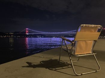 View of illuminated bridge against sky at night