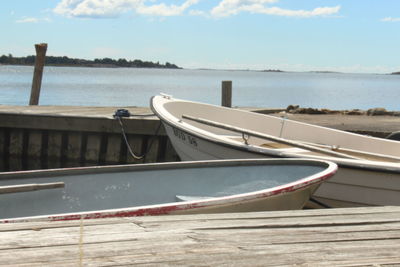 Boat moored on beach against sky