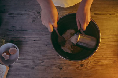 Cropped image of woman preparing food in kitchen