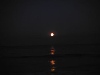 Scenic view of sea against clear sky at night