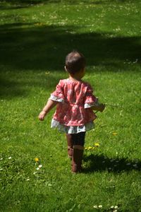 Rear view of boy on field