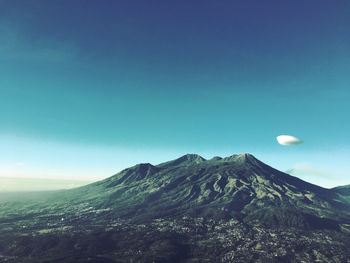 Low angle view of mountain against blue sky