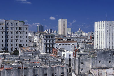 Buildings in city against blue sky