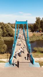 People on bridge against sky