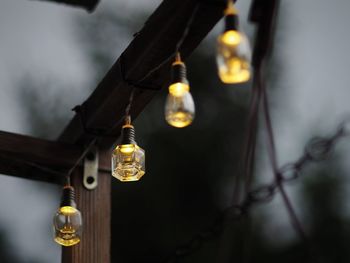 Low angle view of illuminated light bulbs