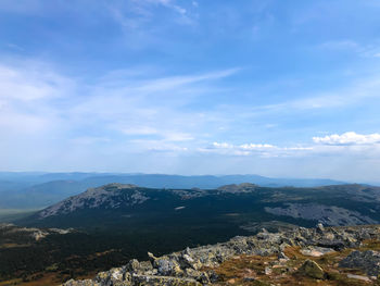 Aerial view of townscape by mountain against sky