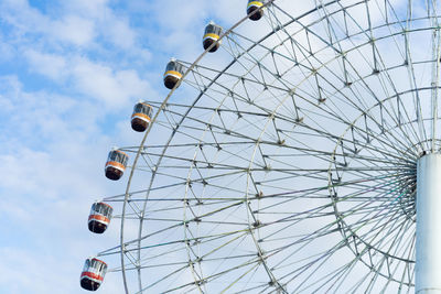 Low angle view of ferris wheel against sky