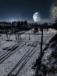 Snow covered railroad tracks against sky