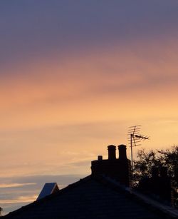 Low angle view of built structure against sky at sunset