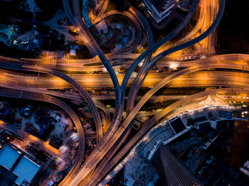 Aerial view of light trails on highway in city