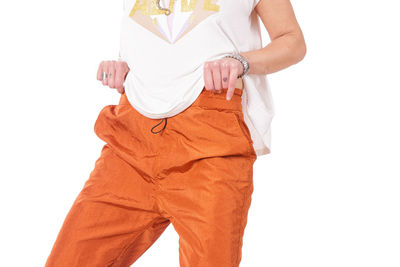 Low section of woman standing against white background