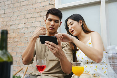 Young couple holding hands at home