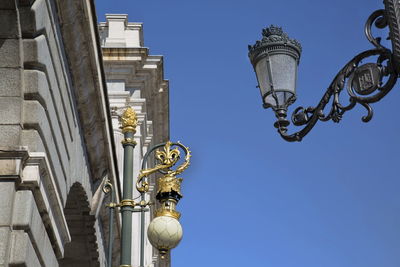 Low angle view of street light against building