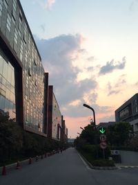 Empty road against cloudy sky