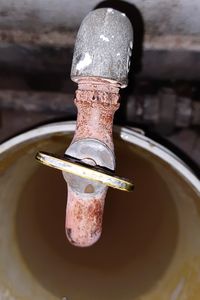 High angle view of old faucet in water