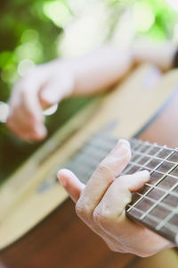 Cropped image of hand playing guitar