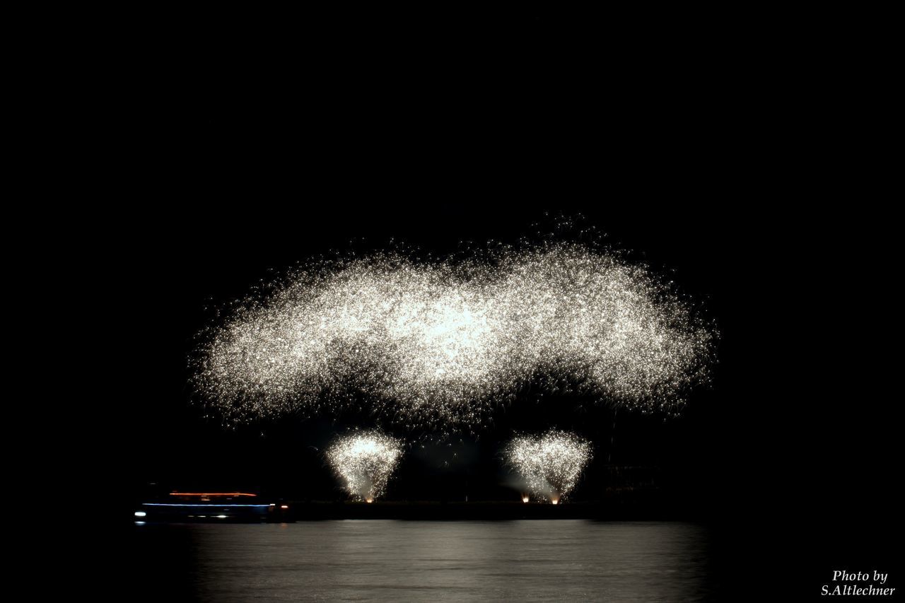 studio shot, black background, no people, motion, exploding, impact, illuminated, water, firework display, close-up