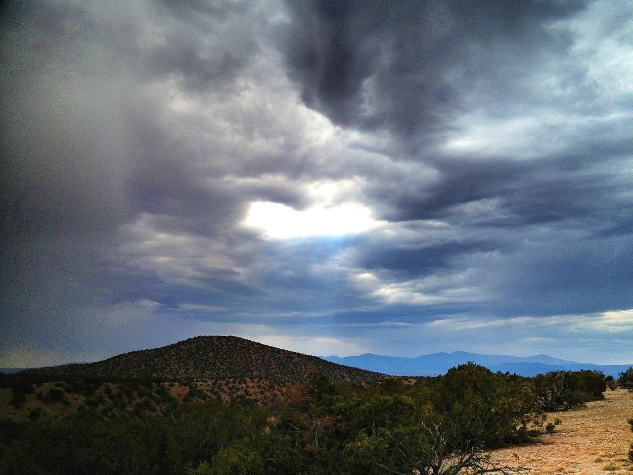 sky, tranquil scene, tranquility, scenics, landscape, cloud - sky, mountain, beauty in nature, cloudy, nature, cloud, mountain range, non-urban scene, idyllic, remote, horizon over land, weather, overcast, hill, outdoors