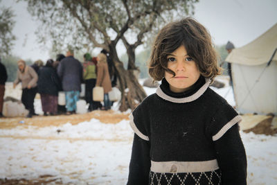 Portrait of teenage girl standing in snow