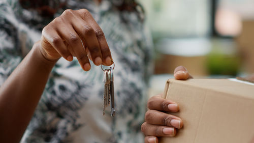 Midsection of woman holding house keys