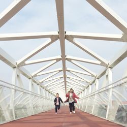 Siblings running on covered bridge