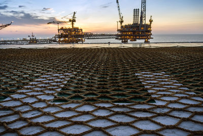 Sunset at oil filed from a helipad of a construction barge