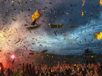 People enjoying at music concert against sky