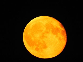 Orange moon over black background