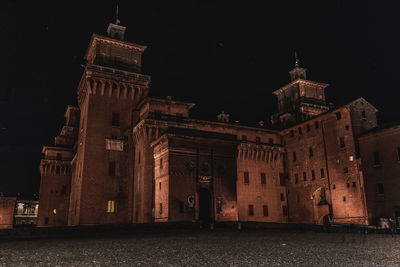 Illuminated building against sky at night