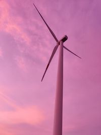 Low angle view of windmill against sky during sunset