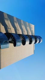 Low angle view of building against clear blue sky