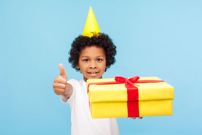 Portrait of a smiling boy against blue background