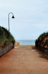 Street by sea against sky