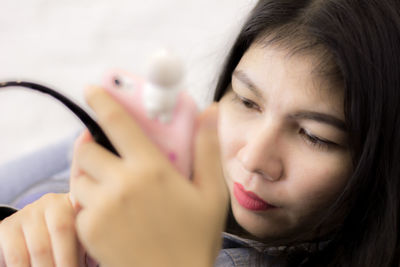 Close-up of young woman using phone