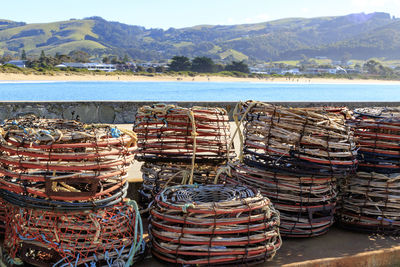 Stack of wicker basket on land against mountains