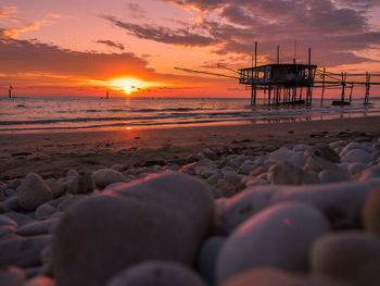 Scenic view of beach against sky during sunset