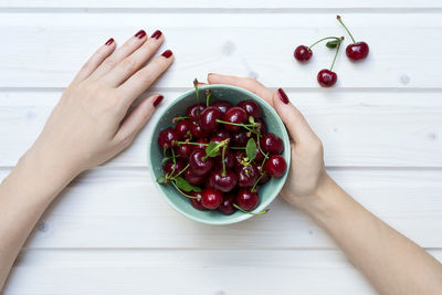 Cropped image of woman holding fruits