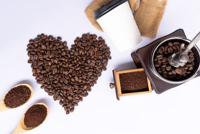 High angle view of coffee beans against white background